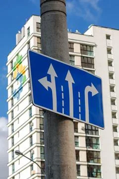 Blue road sign with arrow pointers closeup Stock Photos