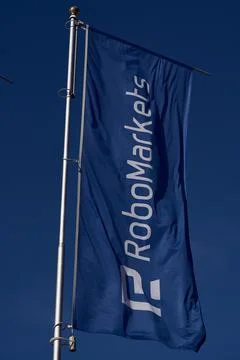 Blue RoboMarkets Flag on flagpole Stock Photos