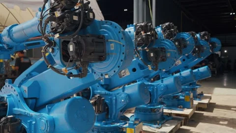 Blue robotic arms stand in warehouse rows 스톡 동영상 344921000