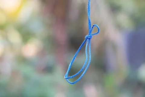 Blue rope hanging loop. Concept,  tying rope knots in daily life. String for fas Stock Photos