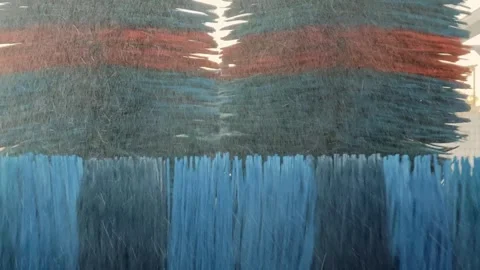 Blue rotating brushes of automatic wash cleaning car body. Closeup of washing Stock Footage 324928308