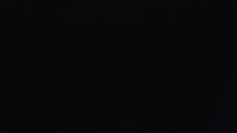 Blue rotating flash against dark background Stock Footage 252601488