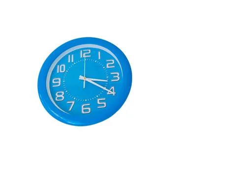 Blue round analog wall clock isolated on a clean white background. Stock Photos