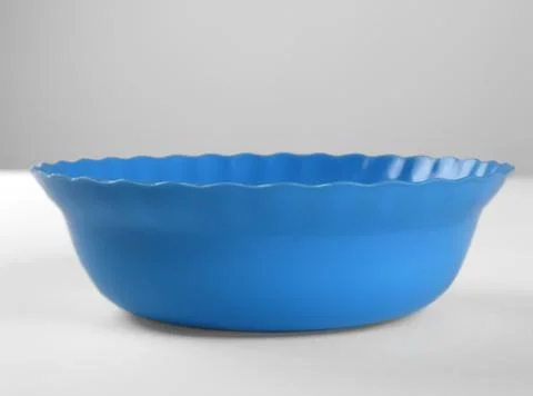 Blue round plastic deep dish, front view Stock Photos