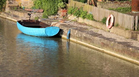 Blue rowing boat floating on a river. Stockbeeldmateriaal 42185802