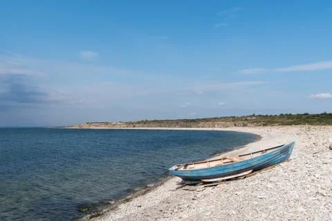 Blue rowing boat by seaside Stock Photos