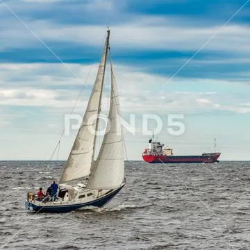 Blue sailboat at journey Stock Photos