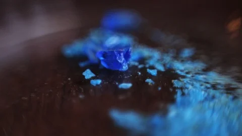 Blue samples of precious metals. Particles of minerals lying on table of Video stock 98553184