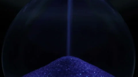Blue Sand falling in hourglass on a dark background. Extreme close-up Stock Footage 67413666