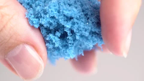 Blue sand is pouring from hands, macro shot. Close-up view woman's hands wi.. Stock Footage 278387358
