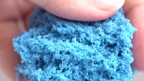 Blue sand is pouring from hands, macro shot. Close-up view woman's hands wi.. Stock Footage 280584290