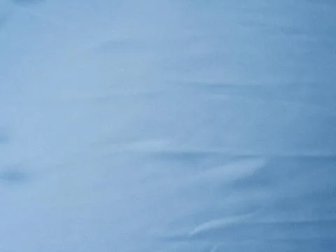 Blue satin texture background with waves and crease Stock Photos
