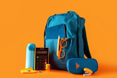 Blue school backpack with different stationery, bottle of water and eyeglasse Stock Photos
