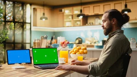 Blue screen and green screen on tablet and laptop near freelancer Stock Photos