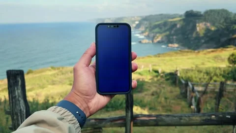 Blue screen chroma key handheld smartphone. Travel with phone concept. Stock Footage 297578082