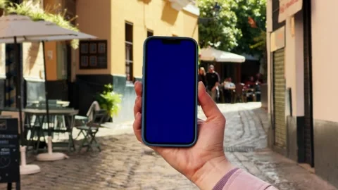Blue screen chroma key smartphone with city view. Travel with phone, application Stock Footage 280693076