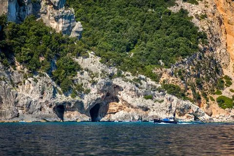 Blue sea and the characteristic caves of Cala Luna, a beach in the Golfo di O Stock Photos