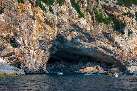 Blue sea and the characteristic caves of Cala Luna, a beach in the Golfo di.. Stock Photos