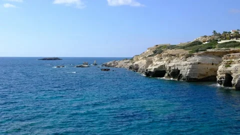 Blue sea and rocky coast on a bright sunny day Stock Footage
