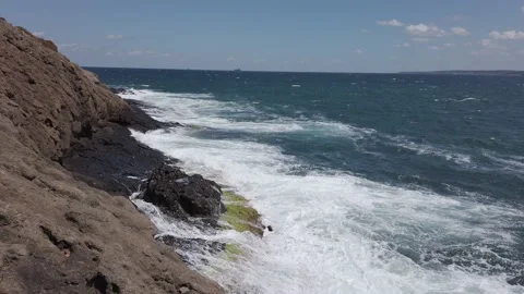 Blue sea. Big waves with white foam. Rocky seashore. Summer vacation concept Stock Footage 137958864