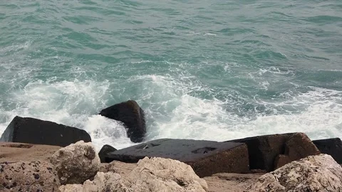 Blue sea. Big waves with white foam. Rocky seashore. Summer vacation concept Stock Footage 137958879
