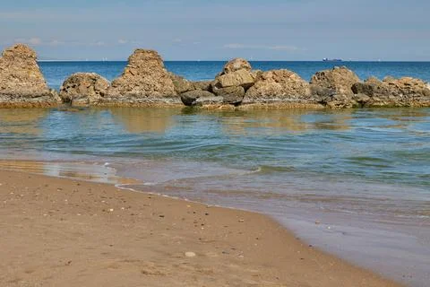 Blue sea, blue sky with clouds and high stones Stock Photos