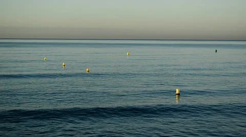 Blue sea with floating yellow elements 01 스톡 동영상 12614529