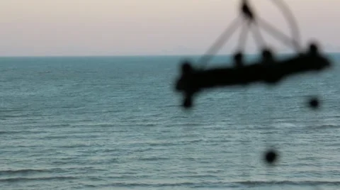 Blue sea with focus moving to wind chimes swaying in the foreground Stock Footage 51034514