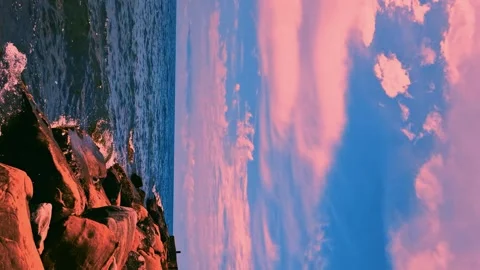 Blue Sea Rocks Pink Clouds Beautiful Blue Sunrise Sky Horizon Vertical Footage.  Video stock 289068690