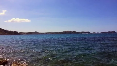 Blue sea on a summer day with cliffs in the background Stock Footage 71771146