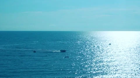 Blue Sea in Sun Rays Sky White Clouds Boat Carries Tourists, Horizon. Water in t Stock Footage 246867987