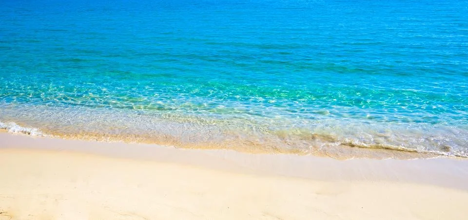 Blue sea surface with waves texture on beach background Stock Photos