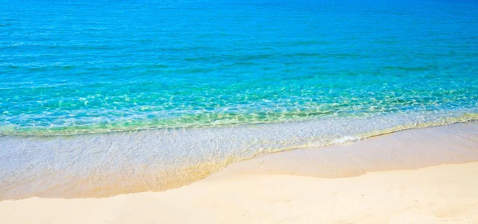 Blue sea surface with waves texture on beach background Stock Photos