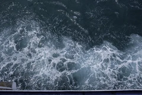 Blue sea texture with waves and foam Stock Photos