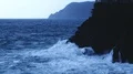 Blue sea water waves crashing into rocky cliff forming foam, stormy weather HD Footage