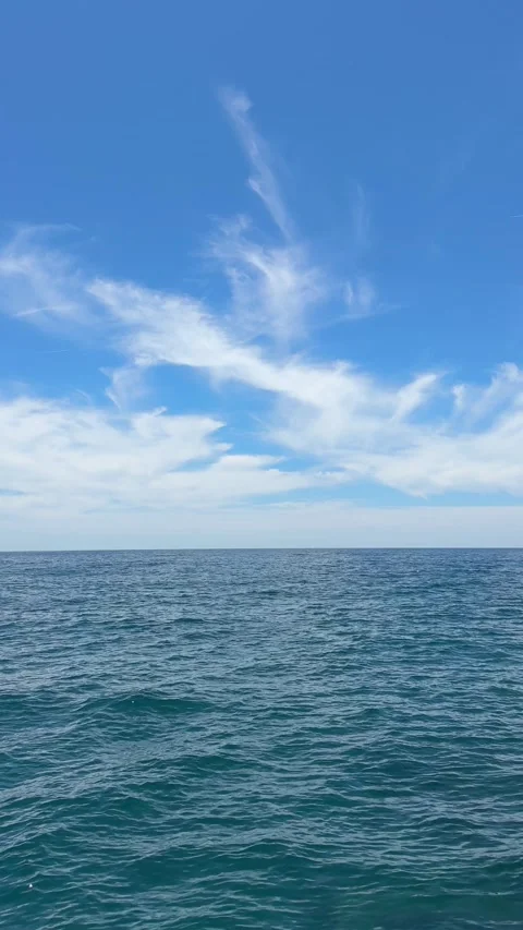 Blue sea waves and sky with beautiful clouds, vertical video. Stock Footage 337050017