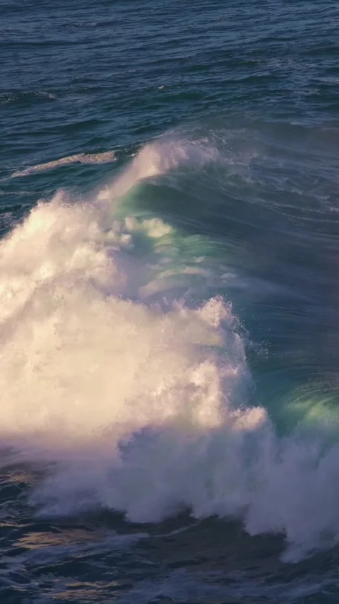 Blue sea waves and the sun reflecting and creating a rainbow on the camera lens Stock Footage 328253913
