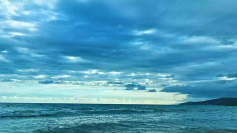 Blue Sea Waves Cloudy Blue Sky Slow Motion Beach Mountains Landscape Background. Stock Footage 288185068