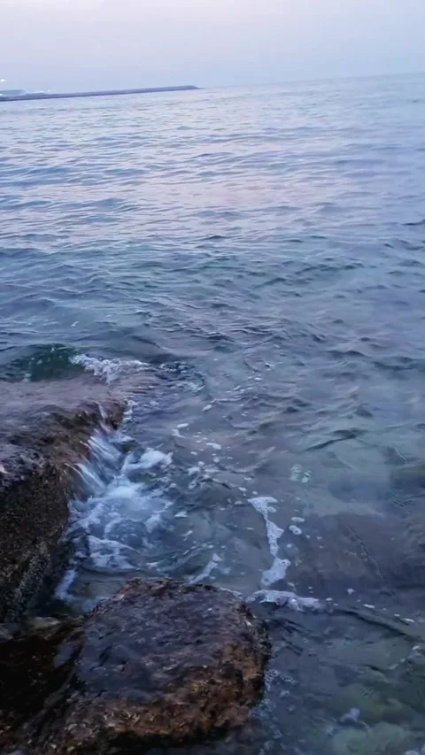 Blue Sea waves floating and hitting with stones on beach in the midnight Stock Footage 264963587