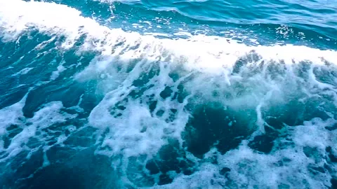 Blue sea waves foaming and splashing, view from the boat. Sea surface footage Stock Footage 154634813