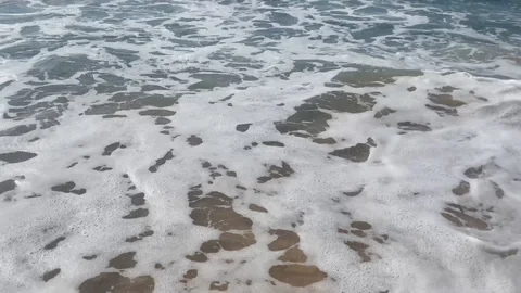 Blue sea waves on the sandy beach in the daytime 4K Video stock 119319035