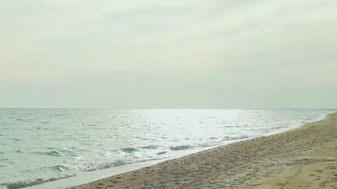 Blue Sea Waves in Sunlight Falling on Sandy Beach Sky Clouds Sun on Sunny Day Su Stock Footage 315093679