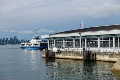 Blue SeaBus ferry docking at modern Lonsdale Quay terminal, North Vancouver Stock Photos