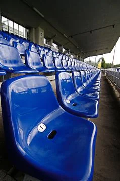 Blue seats in a stadium Stock Photos