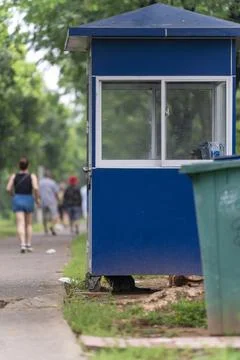 Blue security guard booth in the park, with a few cats underneath Stock Photos