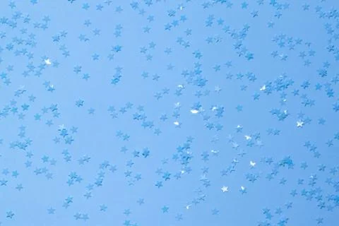 Blue sequins on a blue background. Stock Photos