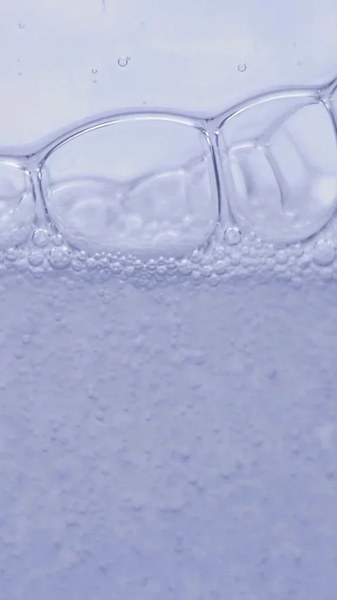 Blue Serum Droplets Floating in Clear Fluid, Luxury Skincare Concept Video stock 328002619