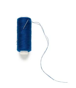 Blue sewing thread spool with needle isolated on white background, closeup Stock Photos