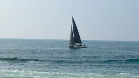 Blue ship sails along wavy calm ocean water. Sailing yacht. Stock Footage 307488501