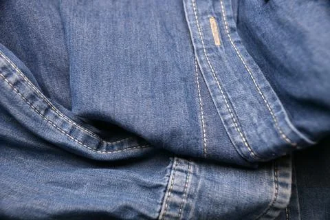 Blue Shirt Button Strip Macro  Creased Fabric Texture Close-Up with Soft De.. Foto stock